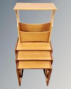 A nest of three 20th century teak G-Plan tables together with a further teak magazine rack