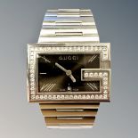 A Gentleman's Gucci wristwatch set with diamonds, the 58 diamonds approximately 1.4ct.