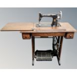 A 20th century Singer sewing machine in oak table