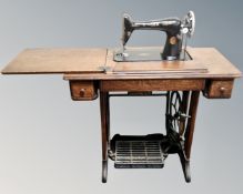 A 20th century Singer sewing machine in oak table