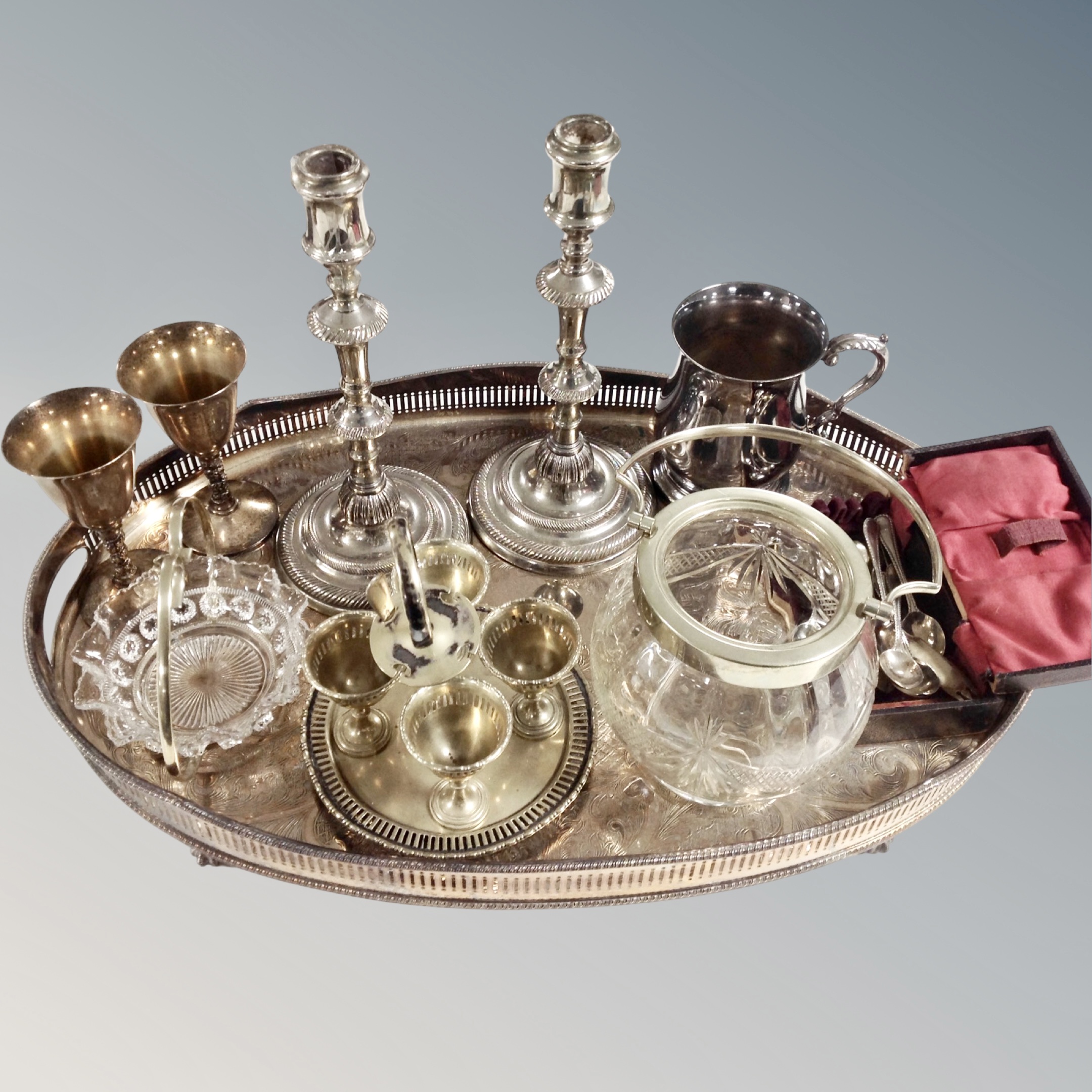 A large silver plated oval gallery tray together with assorted plated wares.
