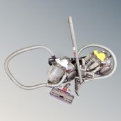 A Dyson DC19 T2 cylinder vacuum together with a further Dyson cylinder vacuum,