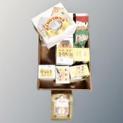 A box containing a quantity of boxed Ringtons commemorative caddies, mugs, ceramic money boxes,