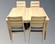 An Ercol Romana extending dining table in oak with matte lacquer finish,