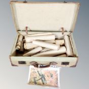 A vintage canvas leather bound trunk containing assorted rolled pictures and prints.