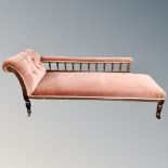 A Victorian chaise longue in buttoned fabric,