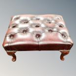 A Chesterfield buttoned oxblood leather footstool