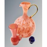 A tangerine art glass jug together with two further glass vases.