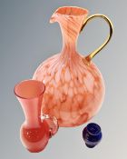 A tangerine art glass jug together with two further glass vases.