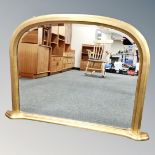 A contemporary gilt arch topped mirror,