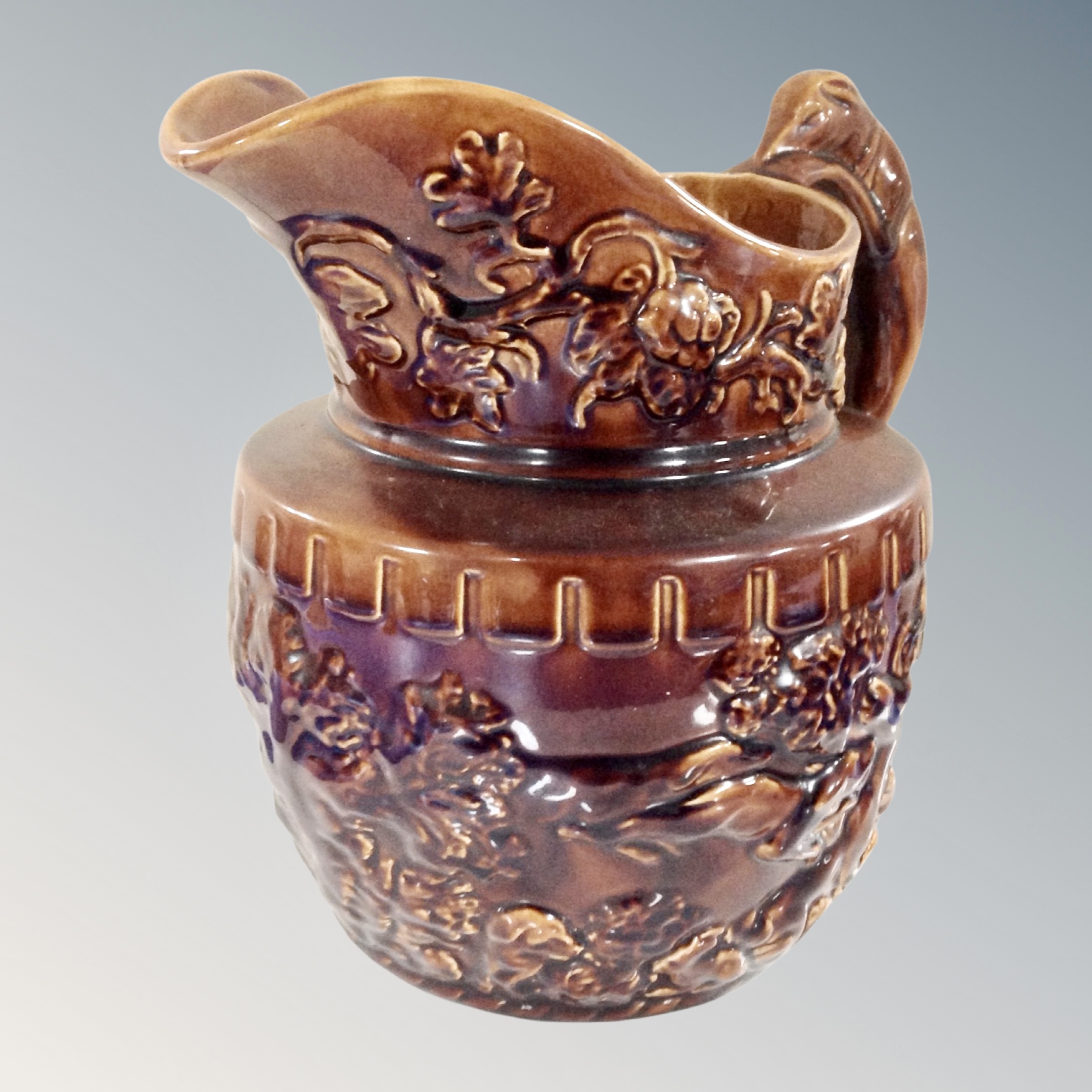 A vintage wood hound handle pottery embossed jug.