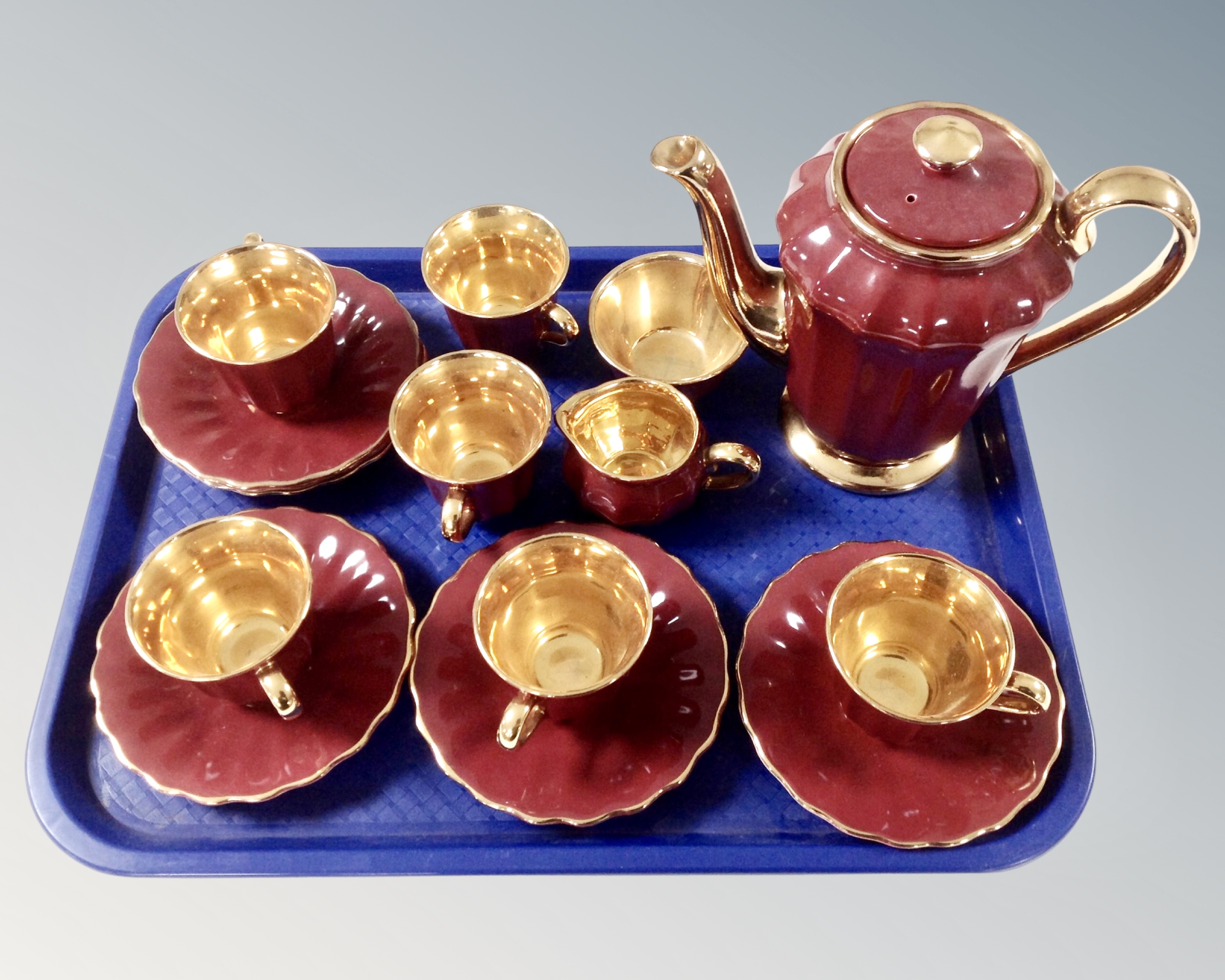 A 15 piece Wade maroon and gilt tea service.