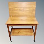 A 20th century teak turn over top trolley
