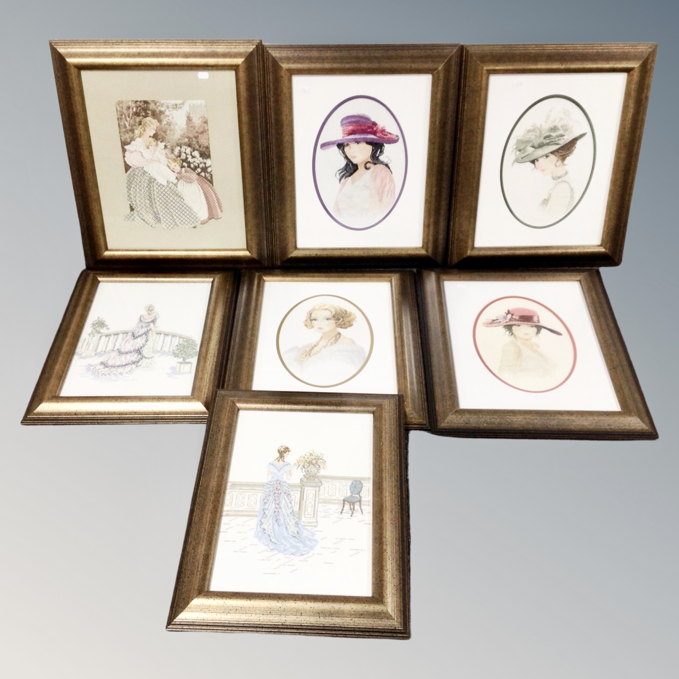 Seven needlework pictures, portraits and ladies in Victorian dress, framed.