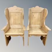 A pair of pine panel backed armchairs