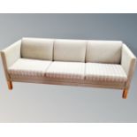 A Scandinavian three seater settee upholstered in a peppermint fabric.