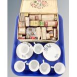 Six Chinese teacups and saucers together with a vintage tin containing assorted bulbs.