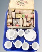 Six Chinese teacups and saucers together with a vintage tin containing assorted bulbs.