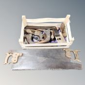 A tray containing a quantity of vintage woodworking tools together with two further handsaws.