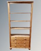 A pair of contemporary pine open bookshelves fitted three drawers beneath,