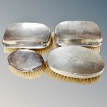 Four solid silver backed and hallmarked grooming brushes