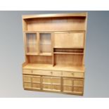A 20th century Nathan teak cocktail wall unit fitted with cupboards and drawers,