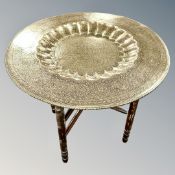 An Indian engraved brass top table