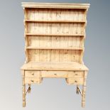 An antique pine kitchen dresser fitted with five drawers,