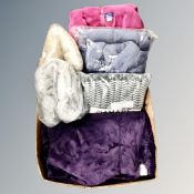 A box containing assorted throws and woolen dressing gowns, tagged and new.
