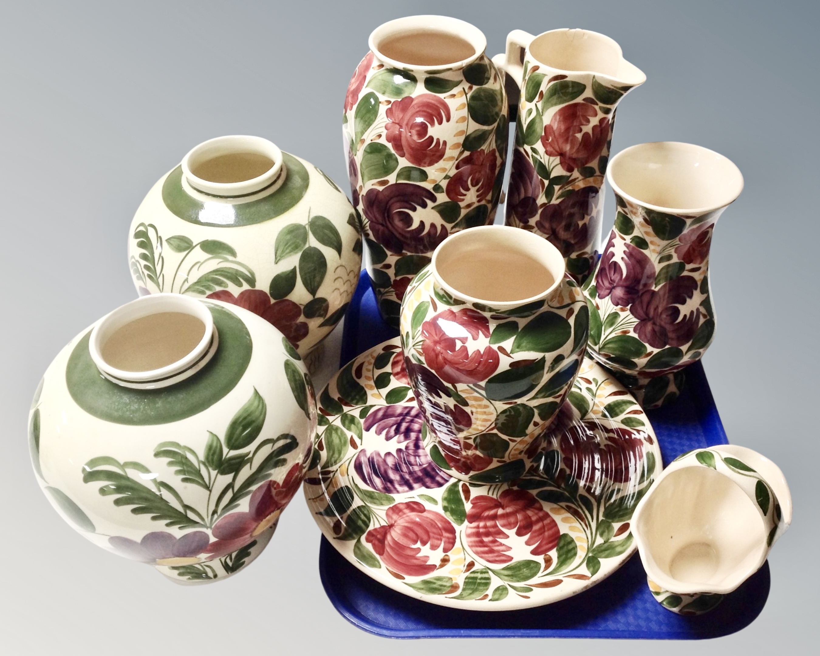 Eight pieces of Wade floral patterned pottery.