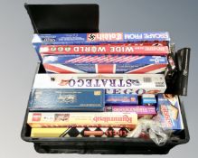 A crate containing assorted board games including Escape from Colditz, Trivial Pursuit, Stratego.