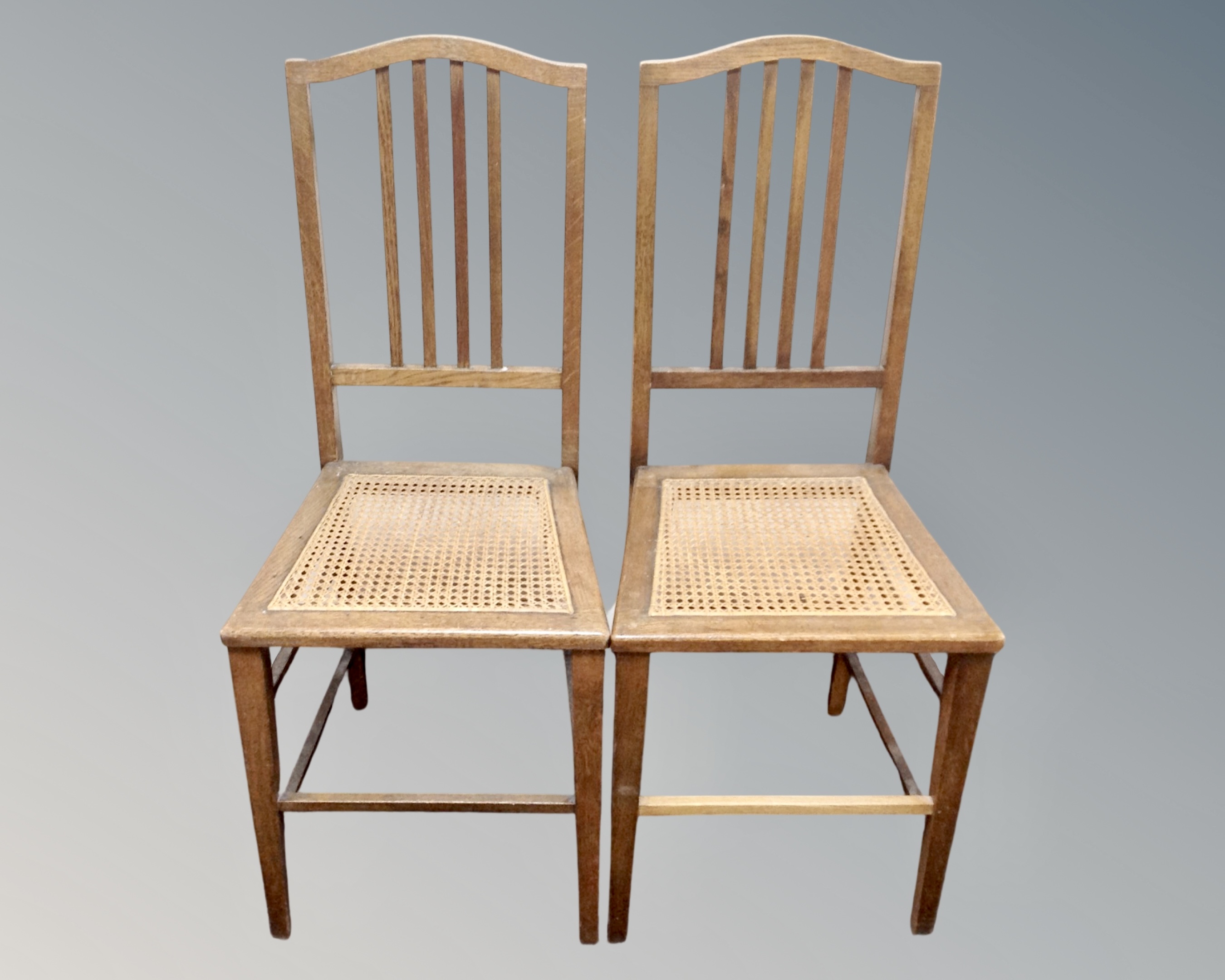 A pair of Edwardian oak bedroom chairs