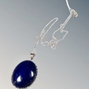 A 25mm Lapis Lazuli cabochon set in silver on a 925 silver chain.