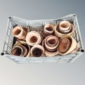 A crate containing a quantity of terracotta plant pots.