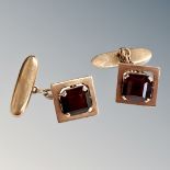 A pair of 14ct gold cufflinks set with garnets CONDITION REPORT: 7.