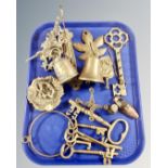 A tray containing assorted brass wares including bells on wall brackets, graduated keys,