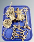 A tray containing assorted brass wares including bells on wall brackets, graduated keys,