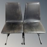 A pair of mid century Pieff black leather dining chairs on metal legs