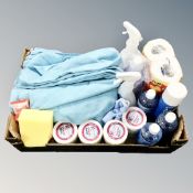 A box containing a quantity of cleaning products including microfibre cloths,