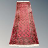 A Bokhara runner, Afghanistan, 100cm by 284cm. CONDITION REPORT: Wear to pile.