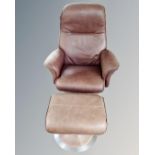 A Scandinavian brown leather revolving armchair with matching footstool.