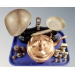 A tray containing a copper and brass kettle together with a set of antique kitchen scales and two