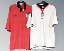 Two replica England football shirts.