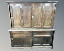 A 19th century stained pine double sliding door school cupboard,