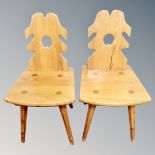 A pair of rustic pine dining chairs