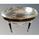 A 19th century French ebonised and brass inlaid oval table,