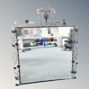 A wrought iron framed mirror.