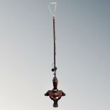 A Regency rosewood pole screen stand on paw feet converted to a standard lamp