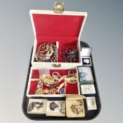 A tray containing a 20th century jewellery box, assorted jewellery pendants on chains,