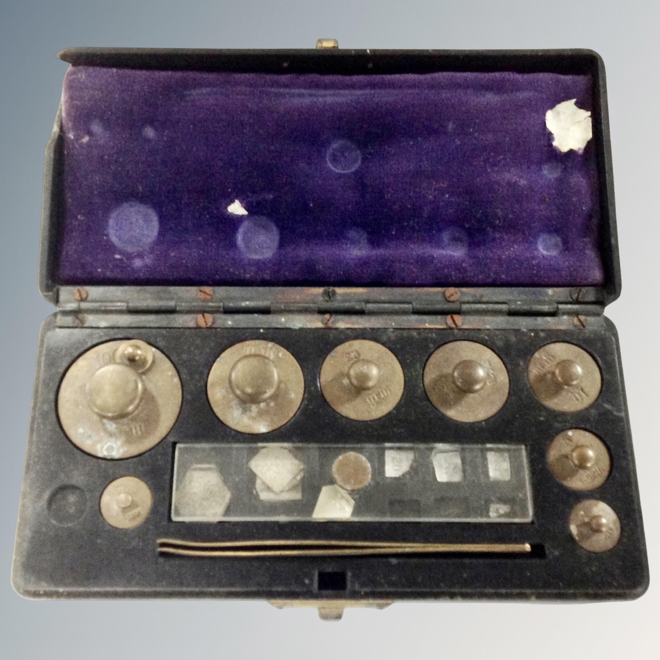 A set of antique brass weights in a Bakelite case together with a further 20th century set of brass